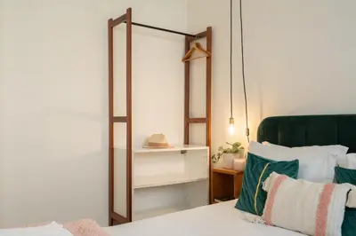 a bedroom with a mirror next to a bed at Jardim do Morro Apartment By Porto Stories in Vila Nova de Gaia