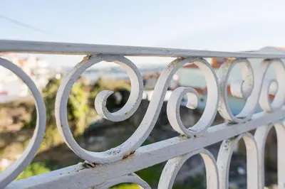a metal bench with a view of the city at PortoNest Downtown Studios in Porto