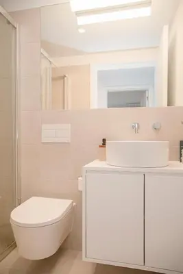 a white bathroom with a toilet and a sink at Liiiving in Porto - Modern & Glam Apartment M in Porto