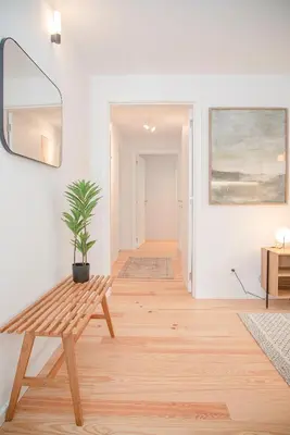 a hallway with a wooden bench and a potted plant at Liiiving in Porto - Modern & Glam Apartment M in Porto
