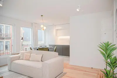 a white living room with a chair and a table at Liiiving in Porto - Modern & Glam Apartment M in Porto