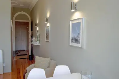 a living room with a white couch and chairs at Apartment Oportoloft in Porto