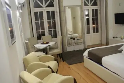 a hotel room with a bed and a bathroom at Apartment Oportoloft in Porto
