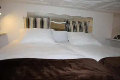 a bed with white sheets and pillows in a room at Apartment Oportoloft in Porto