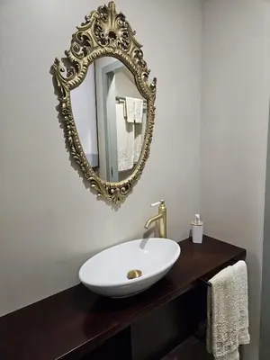 a bathroom with a white sink and a mirror at São João Boutique Apartment in Porto