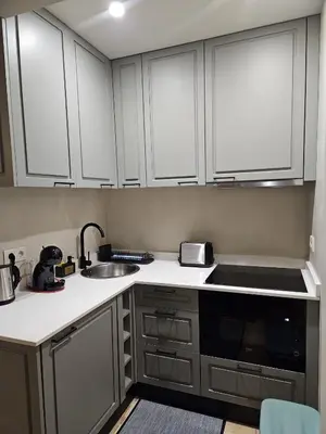 a kitchen with white cabinets and a sink at São João Boutique Apartment in Porto