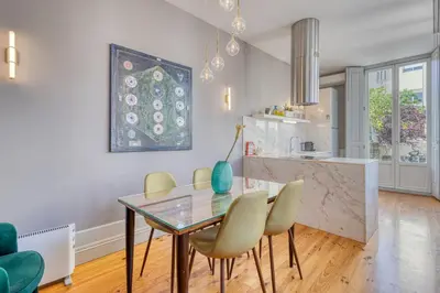 a kitchen and dining room with a glass table and chairs at OPORTO GUEST Luxus Ildefonso in Porto