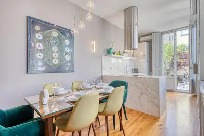 a dining room and kitchen with a table and chairs at OPORTO GUEST Luxus Ildefonso in Porto