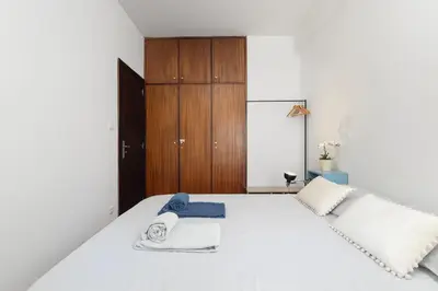 a bedroom with a white bed with towels on it at Porto Cozy Space in Porto