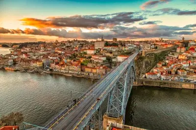 a crowd of people watching a river at sunset at DockApartment in Vila Nova de Gaia