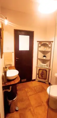 a bathroom with a sink and a toilet and a door at Gulbenkian 39 in Vila Nova de Gaia