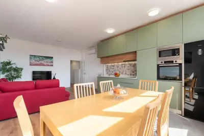 a living room with a red couch and a tv at Host Wise - Comfy Minimalist Flat in Porto
