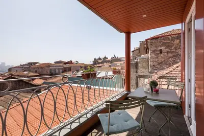 a balcony with a table and a view of a city at Clérigos Design by Hosty in Porto