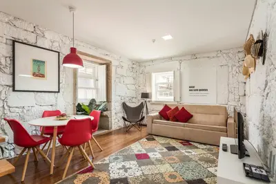 a living room with a couch and a table and chairs at Clérigos Design by Hosty in Porto