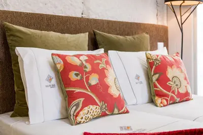 a group of pillows sitting on top of a bed at Clérigos Design by Hosty in Porto