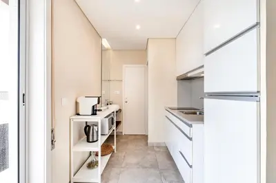 a kitchen with white cabinets and a counter top at VIVA Peaceful Zen Retreat in Porto