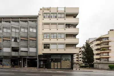 a tall building on the side of a street at VIVA Peaceful Zen Retreat in Porto