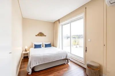 a bedroom with a bed and a large window at VIVA Peaceful Zen Retreat in Porto