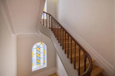 a stairway with a stained glass window and a staircase at Central location with balcony & equipped kitchen in Porto