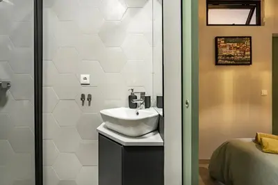 a bathroom with a sink and a shower at Porto Charme Residence in Porto