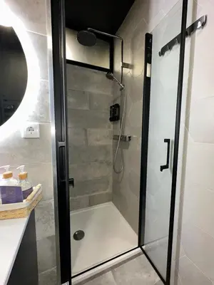 a shower with a glass door in a bathroom at Porto Charme Residence in Porto