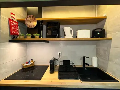 a kitchen with a sink and a counter top at Porto Charme Residence in Porto