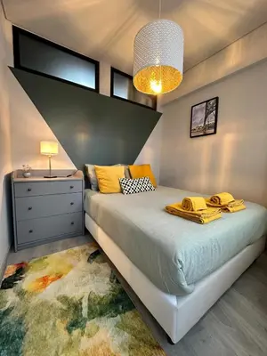 a bedroom with a bed with a dresser and a window at Porto Charme Residence in Porto