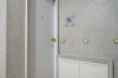 a door with an a sign on a brick wall at Marquês Studio by Amber Star Rent in Porto