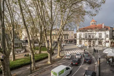 a city street with cars parked in front of a building at Marquês Studio by Amber Star Rent in Porto