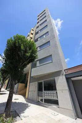 a tall building with a tree in front of it at FLH Boavista Woody Flats in Porto