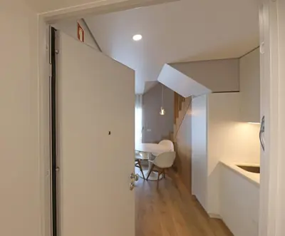 an open door leading into a kitchen with a table at FLH Boavista Woody Duplexes in Porto