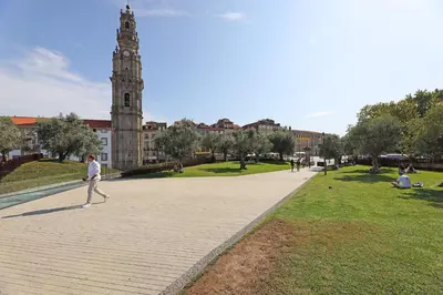 a man walking down a sidewalk in front of a building at FLH Boavista Woody Duplexes in Porto