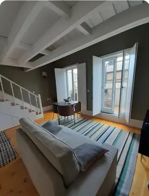 a living room with a couch and a table at Mezzanine in Porto
