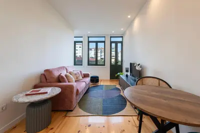 a living room with a couch and a table at Chic Porto Hideaway: Pool & Garden in Porto