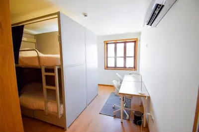 a small room with a bunk bed and a window at Lindo Vale 412 in Porto