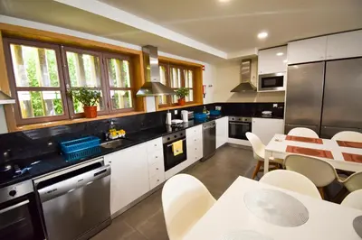 a kitchen and living room with a table and chairs at Lindo Vale 412 in Porto