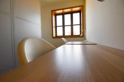 an empty room with a table and a window at Lindo Vale 412 in Porto
