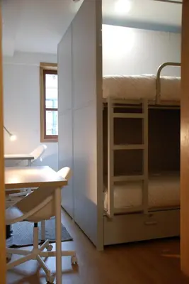 a room with a desk and a bunk bed at Lindo Vale 412 in Porto