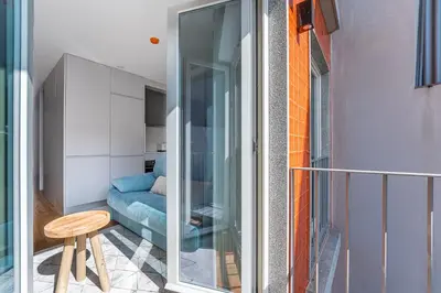 a room with a sliding glass door next to a couch at GuestReady - Downtown Refuge with Private Parking in Porto