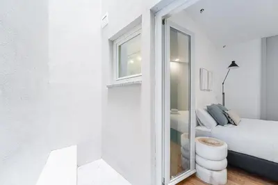 a white room with a bed and a window at GuestReady - Downtown Refuge with Private Parking in Porto