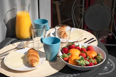 a table with a bowl of strawberries and a bowl of fruit at *Lighty Santa Catarina Studio* Balcony/Dishwasher in Porto