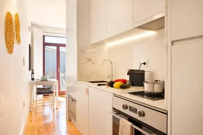 a balcony with a table with food on it at *Lighty Santa Catarina Studio* Balcony/Dishwasher in Porto