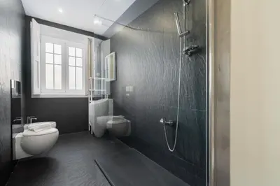 a bathroom with two toilets and a shower at Host Wise - Rustic Central Flats in Porto