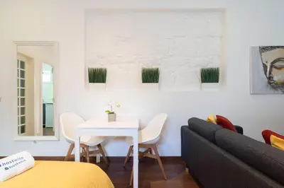 a living room with a white table and a couch at Host Wise - Rustic Central Flats in Porto