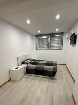 a bedroom with a bed and a window at Porto Encanto- 7 Bedrooms in Porto