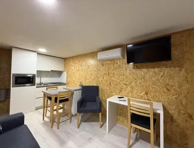 a kitchen with a table and chairs in a room at Porto Encanto- 7 Bedrooms in Porto