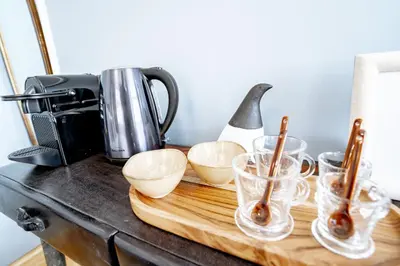 a counter with bowls and cups on a wooden cutting board at Authentic Porto Suites in Porto