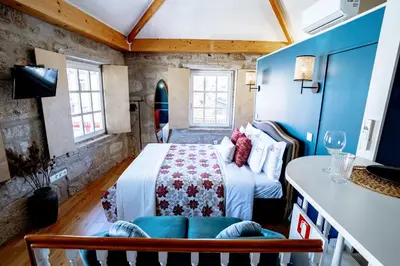 a bedroom with a bed in a room with blue walls at Authentic Porto Suites in Porto