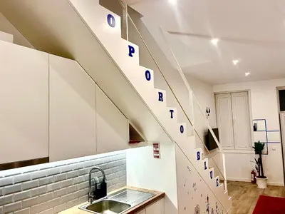 a kitchen with a staircase with blue and white letters on it at Oporto Blue Boavista - Deluxe City Center Duplex in Porto