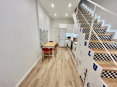 a room with a table and a wine cellar at Oporto Blue Boavista - Deluxe City Center Duplex in Porto